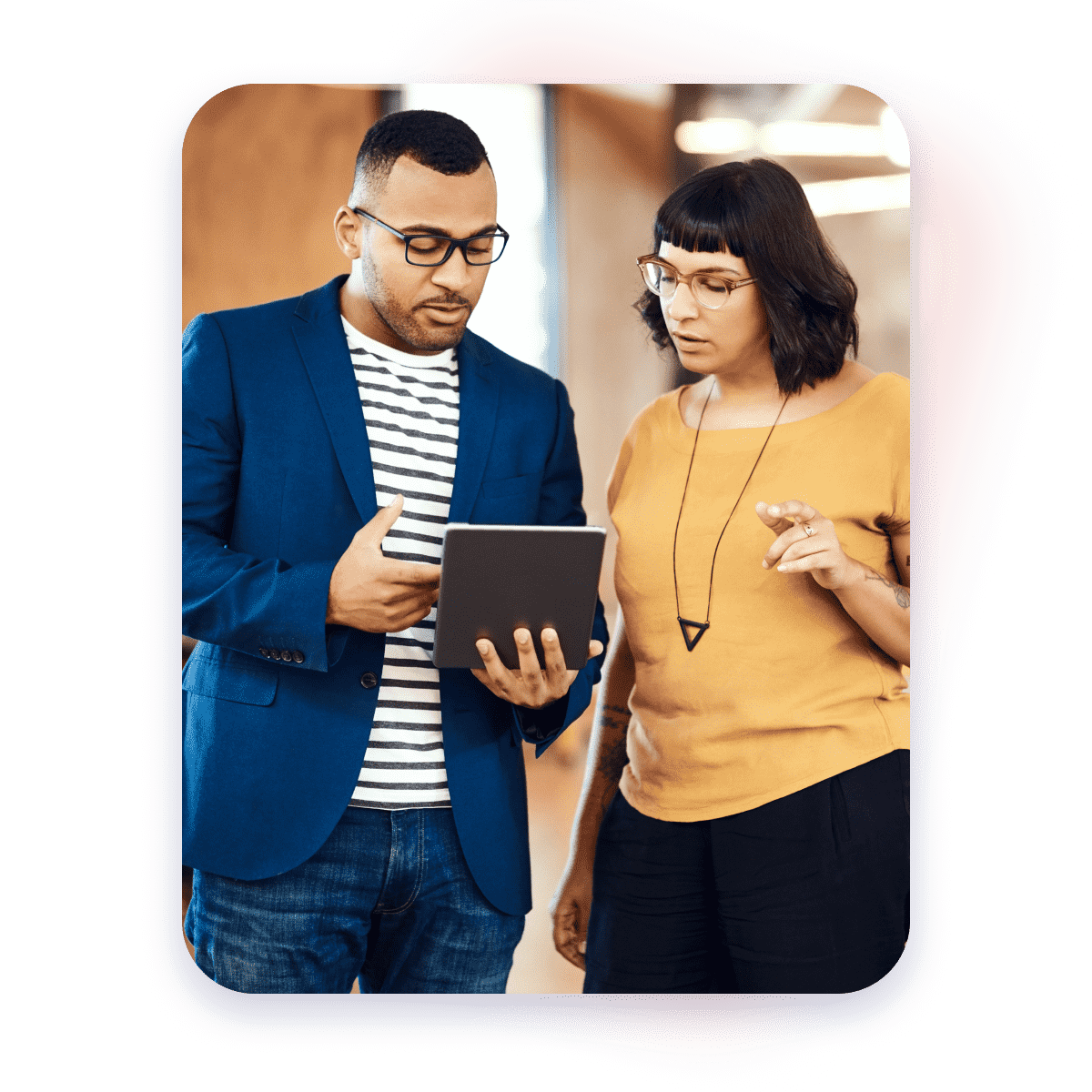 Image of 2 people having a chat while looking at a tablet