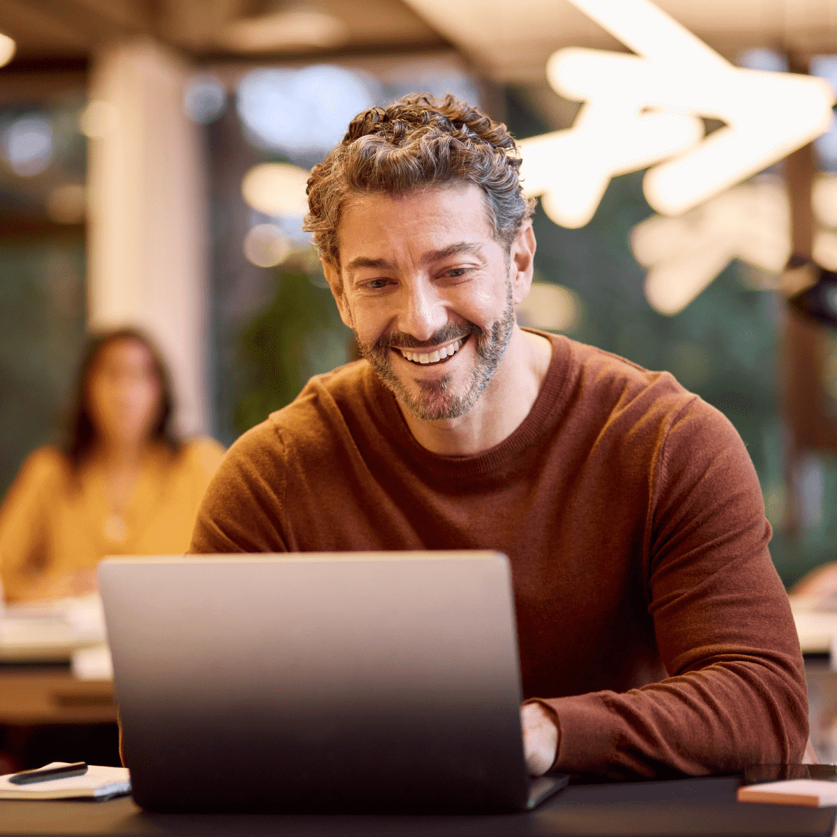 Man working ith a computer while smiling