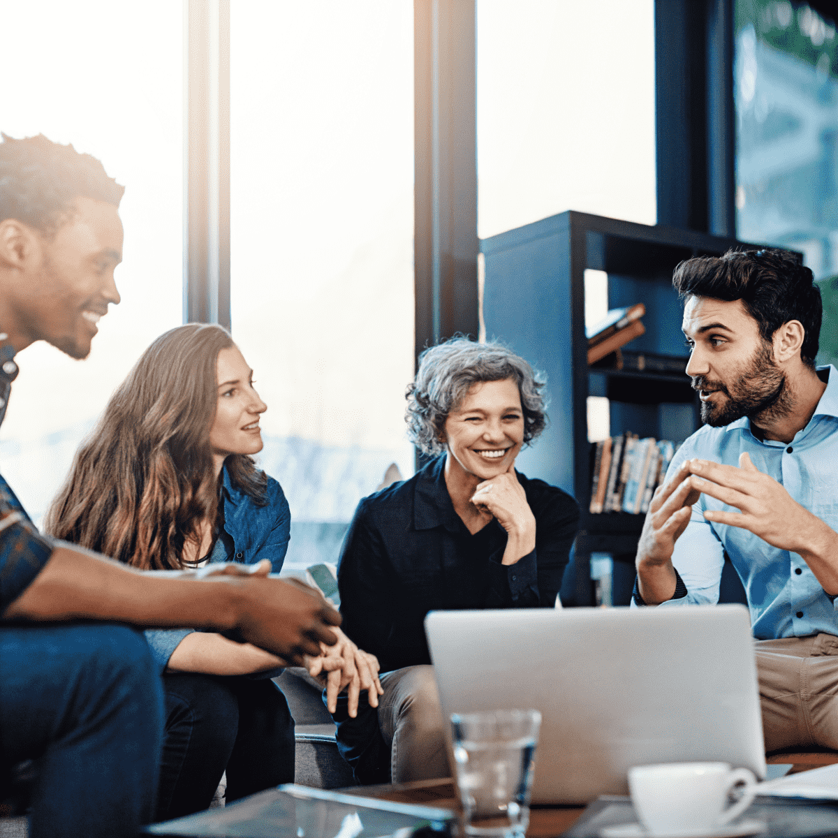 Dynamic and variated group of people having a happy talk in an office